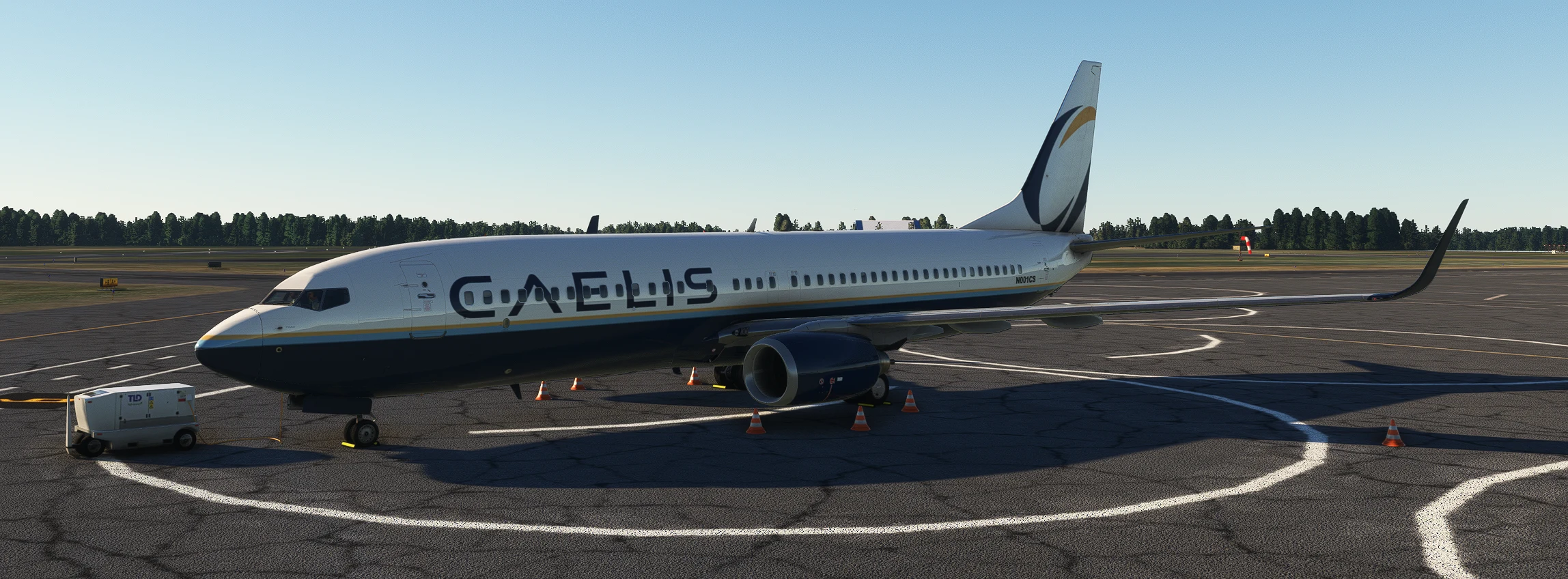 Caelis aircraft viewed from the port side, with the flowing blue and gold tail emblem